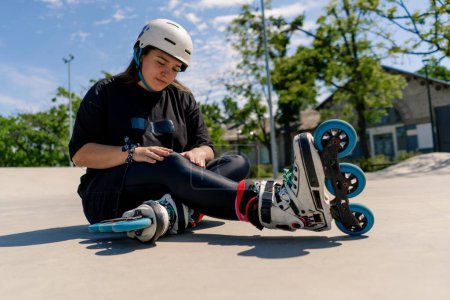 Photo for Upset girl in protective helmet rollerblades crying after fall active recreation skating sport - Royalty Free Image