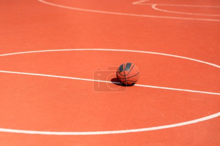 Photo for Close-up of basketball that lies on the floor of a basketball court in a park the concept of love for basketball - Royalty Free Image