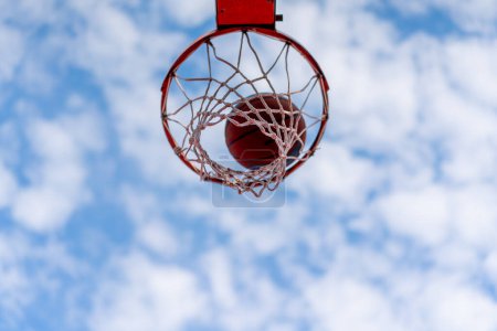Zbliżenie obręczy do koszykówki, do której koszykówka uderza koncepcję podziwu dla gry w koszykówkę i miłości do ćwiczeń
