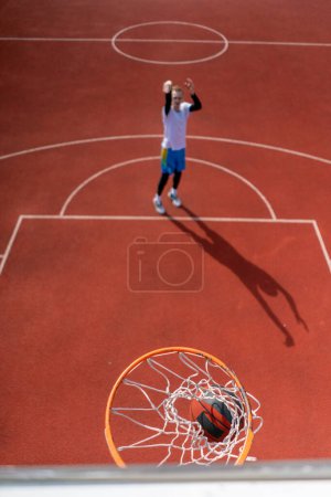 Photo for Close-up of basketball ring into which a tall guy basketball player throws the ball The concept of admiring the game of basketball - Royalty Free Image