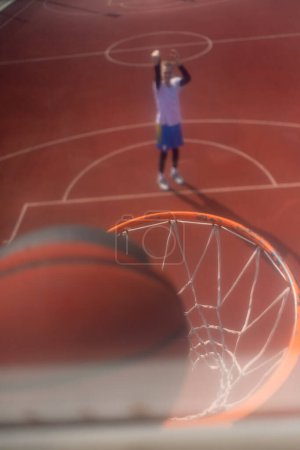 Photo for Close-up of basketball ring into which a tall guy basketball player throws the ball The concept of admiring the game of basketball - Royalty Free Image