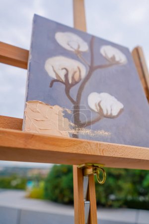 Photo for Close-up of a girl artist applying oil paint with a spatula to a painting in the process of creating painting - Royalty Free Image