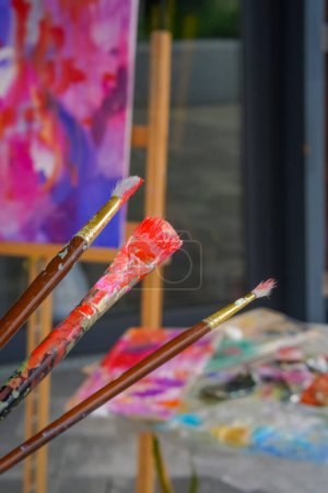 Photo for Close-up of three painting brushes of different sizes in paint the concept of admiration for oil painting - Royalty Free Image