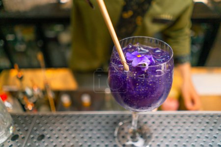 Foto de Recién preparado púrpura cóctel alcohólico puestos en el mostrador de bar en el bar club - Imagen libre de derechos
