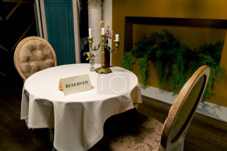 Photo for Close-up of reservation sign reserved standing on a table in an expensive luxury Italian restaurant - Royalty Free Image