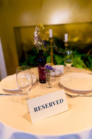 Photo for Close-up of reservation sign reserved standing on a table in an expensive luxury Italian restaurant - Royalty Free Image