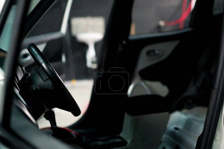Photo for A close-up of the interior of a luxury white car from which the seats were taken out while the car was being washed - Royalty Free Image