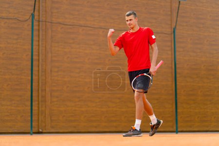 Photo for Portrait of a young professional tennis player rejoices at the victory at the tournament competition on open court winner sport game - Royalty Free Image