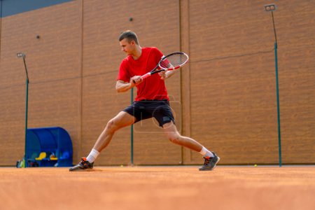 Photo for Young professional player coach outdoor tennis court practicing strokes with racket and tennis ball playing against opponent - Royalty Free Image