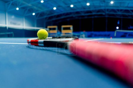 Photo for Close-up sports equipment tennis ball and racket lie indoor professional blue court hobby competition sport - Royalty Free Image
