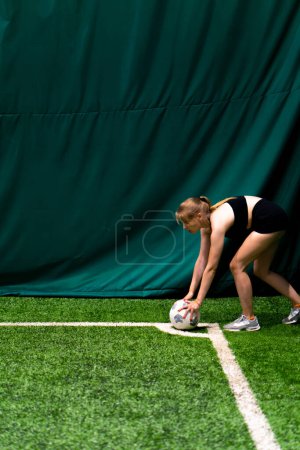 Photo for A young girl during a football match prepares to throw a corner to her partner wants to win game forms a strategy - Royalty Free Image