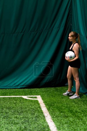 Photo for A young girl during a football match prepares to throw a corner to her partner wants to win game forms a strategy - Royalty Free Image