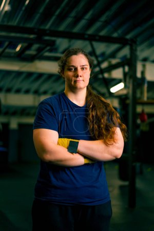 Téléchargez les photos : Portrait de fatigué forte fille grave boxeur entraîneur dans la salle de gym après combat entraînement concept de sport - en image libre de droit