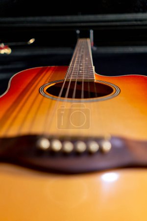 Photo for Close-up shot of classical acoustic guitar strings from wood hanging on the wall in a music studio - Royalty Free Image