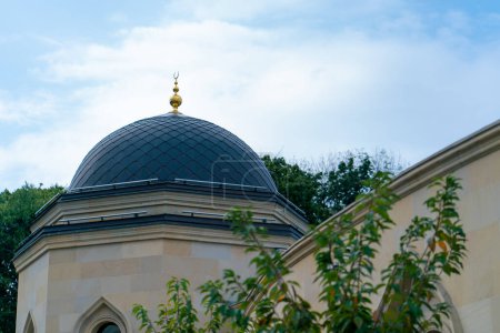 Photo for Close-up shot of the gambiz dome with a crescent moon on top of a Muslim mosque against a blue sky - Royalty Free Image