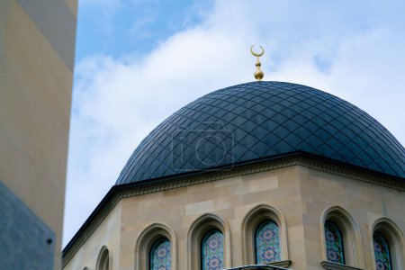 Photo for Close-up shot of the gambiz dome with a crescent moon on top of a Muslim mosque against a blue sky - Royalty Free Image