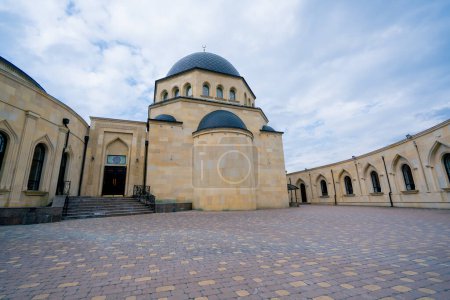 Photo for Wide angle shot of the courtyard of a large beautiful Muslim mosque with a gambiz dome and a crescent moon on top against a blue sky - Royalty Free Image