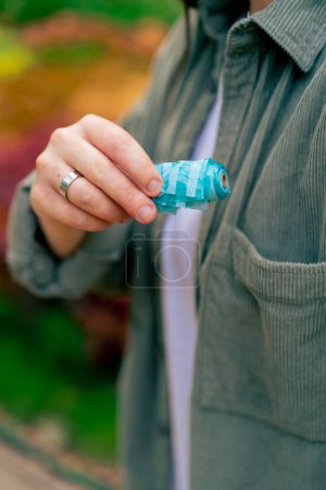 Photo for Close-up female hand holding trash bags for cleaning after pet park animal care - Royalty Free Image