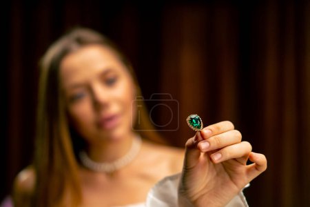 Photo for Close-up young beautiful girl carefully examines the beads before starting the production of craft jewelry - Royalty Free Image