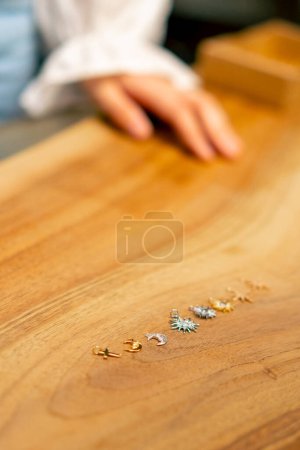 Photo for Close-up of female hands creative girl needlewoman chooses beads bracelet craft jewelry - Royalty Free Image