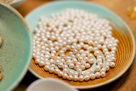 Foto de Cerca de perlas de perlas para collares o pulseras o anillos se encuentra en la producción artesanal de mesa hobby belleza - Imagen libre de derechos