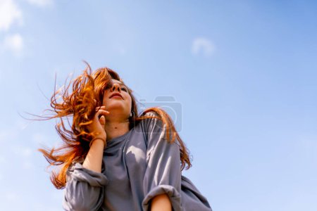 Photo for Young red-haired street hip-hop dancer in sportswear dances impromptu dance us bridge attract the attention passers-by hobbies active lifestyle - Royalty Free Image