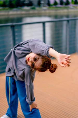 Photo for Young street hip hop dancer in sportswear doing warmup before dance rehearsal hobby active lifestyle - Royalty Free Image