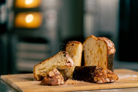 Foto de Primer plano del pan de Pascua recién horneado con pasas, albaricoques secos y almendras en una tabla de madera - Imagen libre de derechos