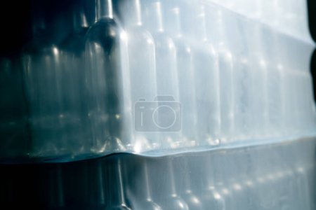 Photo for Close-up shot of empty glass bottles standing in a row prepared for filling with wine at a winery - Royalty Free Image