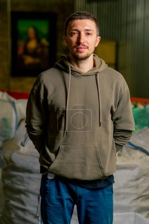 Photo for Portrait of a male worker employee at a waste processing and waste sorting station at a special plant - Royalty Free Image