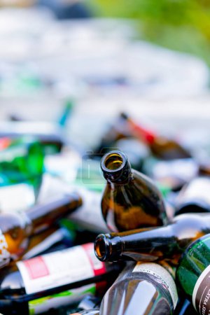 Photo for Close-up shot of glass bottles packed in a special garbage bag at a waste recycling station for its disposal - Royalty Free Image