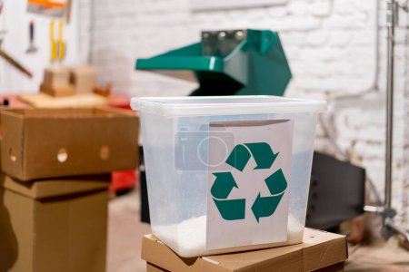 Photo for Close-up shot of a container with a recycling sticker filled with shredded plastic bottle caps - Royalty Free Image