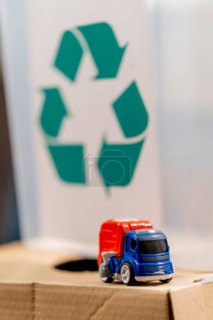 Photo for Close-up shot of a toy made of plastic against the background of a container filled with crushed plastic caps - Royalty Free Image