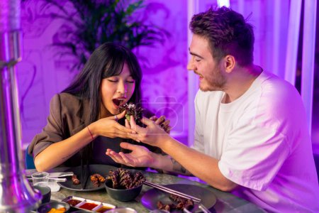 Photo for Couple in love korean grill restaurant taste various traditional dishes feed each other food concept - Royalty Free Image