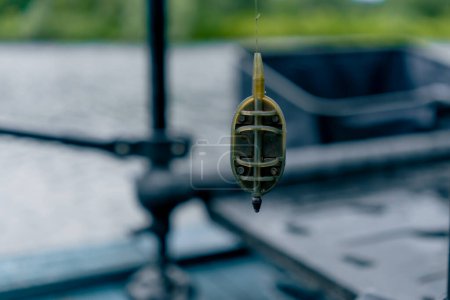 Photo for Close-up fishing edible bait hanging on a hook on the background of river nature sport fishing feeder free style method - Royalty Free Image