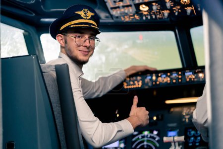 Photo for Portrait of smiling plane captain in uniform preparing flight in flight simulator cockpit - Royalty Free Image