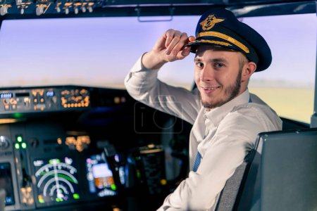 Photo for Portrait of smiling plane captain in uniform preparing flight in flight simulator cockpit - Royalty Free Image