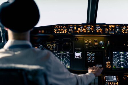 Photo for The pilot in the cockpit controls the plane during flight turbulence flight simulator transportation - Royalty Free Image