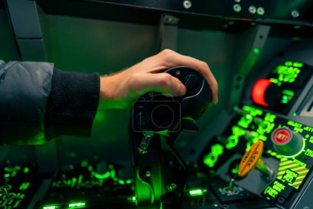 Photo for Close-up of the cockpit of a military plane a pilot with a steering wheel and many buttons on the control panel of airplane flight simulator - Royalty Free Image