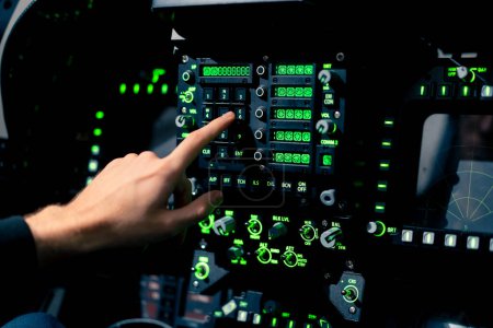 Photo for Close-up hand of the pilot captain presses the buttons on the control panel to start the engine of plane Flight simulator close-up - Royalty Free Image