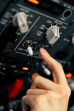Photo for Close-up hand of the pilot captain presses the buttons on the control panel to start the engine of plane Flight simulator close-up - Royalty Free Image