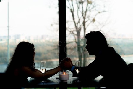 Photo for Couple in love on a date holding hands in a restaurant concept love and support romance - Royalty Free Image