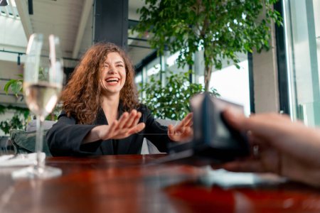 Photo for Portrait of young beautiful curly woman in shock happy with marriage proposal from boyfriend with wedding ring restaurant romance - Royalty Free Image