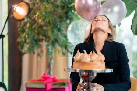 Téléchargez les photos : Portrait d'une fille heureuse anniversaire profitant d'un gâteau festif lors d'une fête au restaurant avec des cadeaux - en image libre de droit