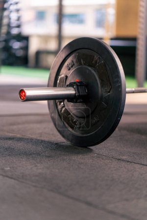 Photo for Close-up of a barbell with athletic plates on the floor in a sports club - Royalty Free Image