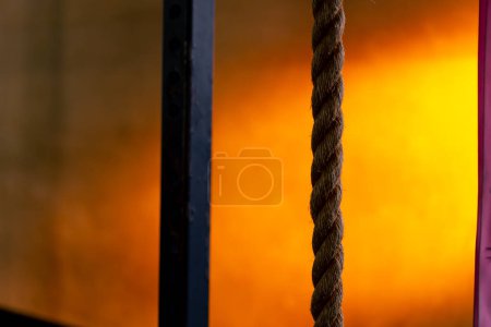 Photo for Close-up of ropes for exercise in a sports club on a bright orange background - Royalty Free Image