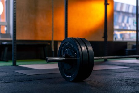 Photo for Close-up in a sports club of athletic plates on a barbell for on a bright orange background - Royalty Free Image
