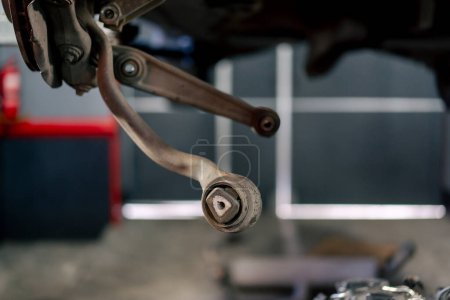 Foto de Primer plano de una almohadilla de freno oxidada en un soporte de rueda metálica en una estación de servicio - Imagen libre de derechos