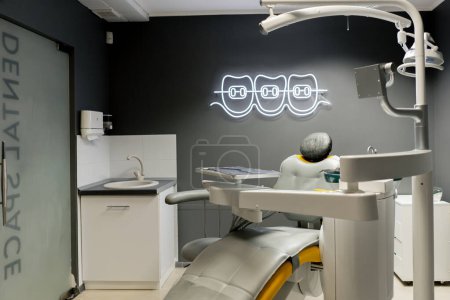 Foto de Consultorio dental blanco estéril listo para robots silla amarilla para el paciente y el equipo blanco - Imagen libre de derechos