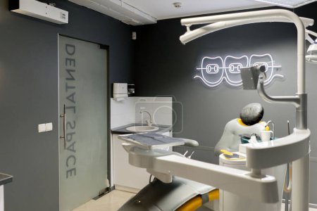 Photo for Dental office white sterile ready for robots yellow chair for the patient and white equipment - Royalty Free Image